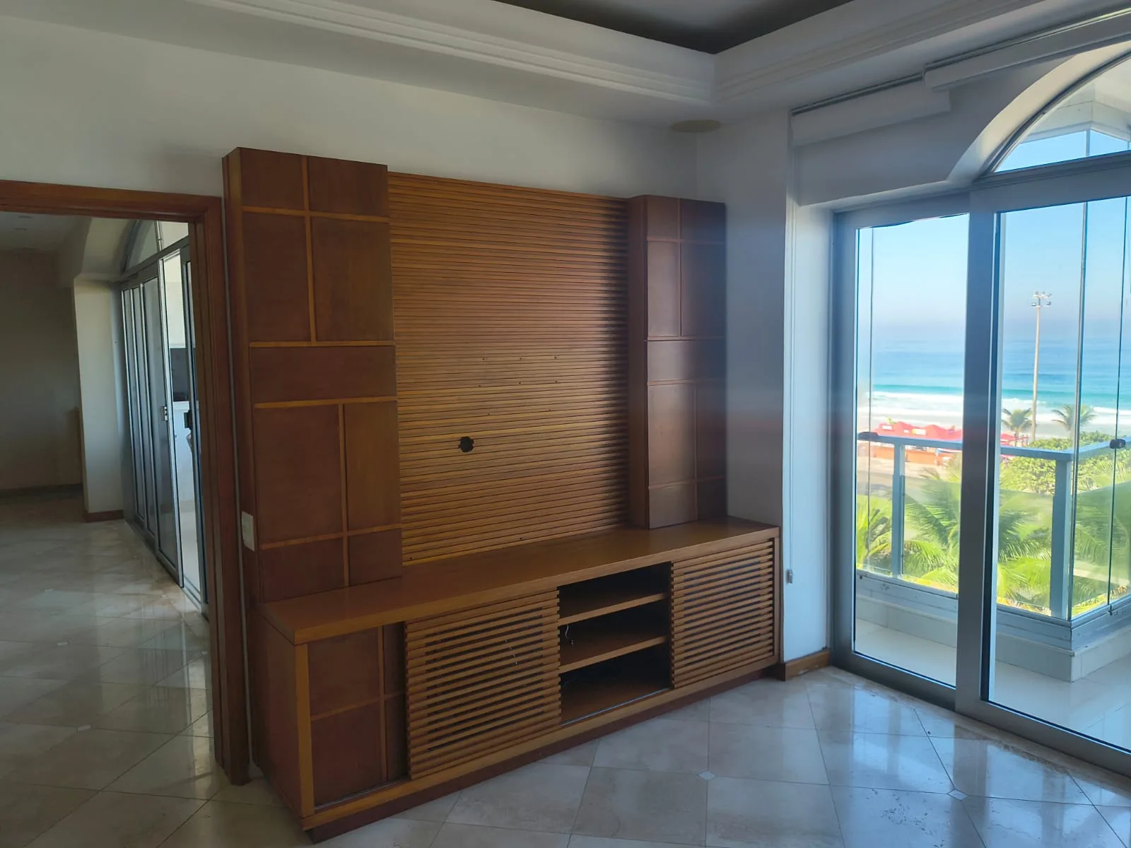 Sala de TV com painel ripado em madeira e marcenaria sob medida